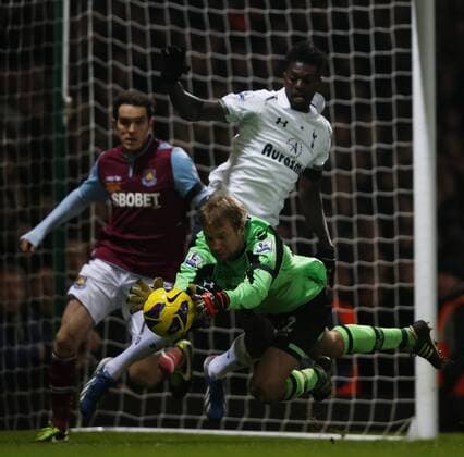 LONDON, Jussi Jaaskelainen (below), goalie of West Ham United saves as Emmanuel Adebayor (above) of Tottenham Hotspur attacks during the Barclays Premier League match between West Ham United and Tottenham Hotspur at the Boleyn Ground, Upton Park, in London, Britain on February 25, 2013. Tottenham Hotspur won 3-2 and lift into third in the table. (Xinhua Wang Lili) FOR EDITORIAL USE ONLY. NOT FOR SALE FOR MARKETING OR ADVERTISING CAMPAIGNS. NO USE WITH UNAUTHORIZED AUDIO, VIDEO, DATA, FIXTURE LISTS, CLUB LEAGUE LOGOS OR LIVE SERVICES. ONLINE IN-MATCH USE LIMITED TO 45 IMAGES, NO VIDEO EMULATION. NO USE IN BETTING, GAMES OR SINGLE CLUB LEAGUE PLAYER PUBLICATIONS. BRITAIN-LONDON-SOCCER-PREMIER LEAGUE-TOTTENHAM HOTSPUR VS WEST HAM UTD