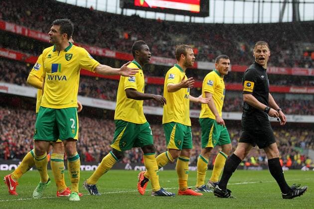 Norwich s players argue with referee Mike Jones after the award of a penalty.. FC Arsenal London vs Norwich City - Barclays Premier League - Emirates Stadium, London- 12 04 13 - EDITORIAL USE ONLY. No use with unauthorised audio, video, data, fixture lists, club league logos or live services. Online in-match use limited to 120 images, no video emulation. No use in betting, games or single club league player publications.