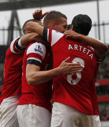 LONDON, April 13, 2013 - Lukas Podolski (2nd, L) of Arsenal celebrates scoring with his teammates during the Barclays Premier League match between Arsenal and Norwich City at the Emirates Stadium in London, Britain, on April 13, 2013. Arsenal won 3-1. (Xinhua Wang Lili)