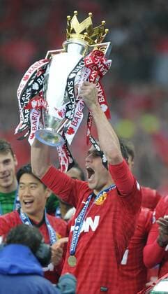 Robin van Persie of Manchester United lifts the Premier League trophy - Barclays Premier League - Manchester United ManU - Old Trafford Stadium - Manchester - England - 12 05 13 - EDITORIAL USE ONLY. No use with unauthorised audio, video, data, fixture lists, club league logos or live services. Online in-match use limited to 120 images, no video emulation. No use in betting, games or single club league player publications.