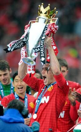 Robin van Persie of Manchester United lifts the Premier League trophy - Barclays Premier League - Manchester Utd City - Old Trafford Stadium - Manchester - England - 12 05 13 - EDITORIAL USE ONLY. No use with unauthorised audio, video, data, fixture lists, club league logos or live services. Online in-match use limited to 120 images, no video emulation. No use in betting, games or single club league player publications.