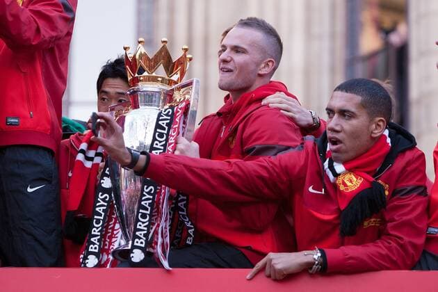 Tom Cleverley and Chris Smalling of Manchester United with the trophy - Manchester United - Premier League Trophy Parade - Manchester - England -13 05 2013 - EDITORIAL USE ONLY. No use with unauthorised audio, video, data, fixture lists, club league logos or live services. Online in-match use limited to 120 images, no video emulation. No use in betting, games or single club league player publications.