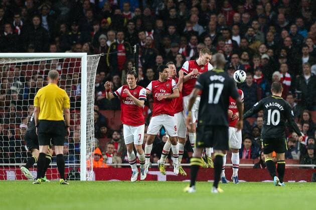 Football - 2012 2013 Premier League - Arsenal vs Wigan Wigan s Shaun Maloney scores a free kick at the Emirates Stadium, London