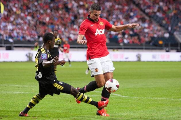 Robin van Persie of Manchester United skips past Ebeneser Ofori of AIK - AIK Stockholm vs. Manchester United - Friendly - Stockholm - Sweden - 06 08 2013 Pic Philip Oldham Sportimage EDITORIAL USE ONLY. No use with unauthorised audio, video, data, fixture lists, club league logos or live services. Online in-match use limited to 120 images, no video emulation. No use in betting, games or single club league player publications.