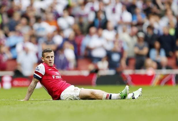 Arsenal s Jack Wilshere looks on dejected after getting fouled - FC Arsenal London vs Aston Villa FC - Barclays Premiership - Emirates Stadium - London - England -17 08 2013 - EDITORIAL USE ONLY. No use with unauthorised audio, video, data, fixture lists, club league logos or live services. Online in-match use limited to 120 images, no video emulation. No use in betting, games or single club league player publications.