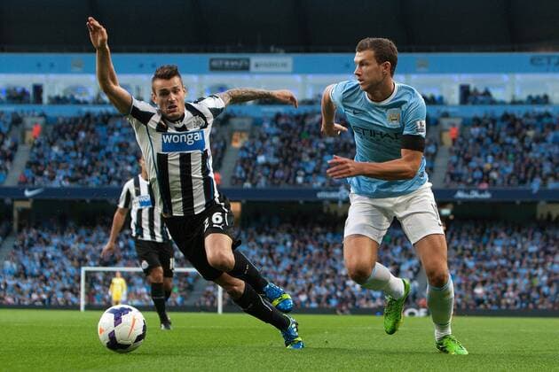 Edin Dzeko of Manchester City breaks past Hatem Ben Arfa of Newcastle United - Manchester City vs. Newcastle United - Premier League - Etihad Stadium - Manchester - 19 08 2013 Pic Philip Oldham Sportimage EDITORIAL USE ONLY. No use with unauthorised audio, video, data, fixture lists, club league logos or live services. Online in-match use limited to 120 images, no video emulation. No use in betting, games or single club league player publications.