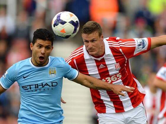 Sergio Kun Aguero of Manchester City tussles with Robert Huth of Stoke City- Barclays Premier League - Stoke City vs Manchester City - Britannia Stadium - Stoke on Trent - 14 09 13 - EDITORIAL USE ONLY. No use with unauthorised audio, video, data, fixture lists, club league logos or live services. Online in-match use limited to 120 images, no video emulation. No use in betting, games or single club league player publications.
