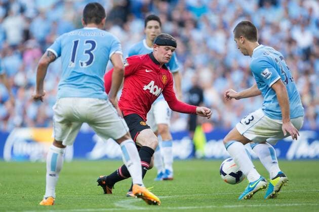 Wayne Rooney of Manchester United struggles to pass the City defence - Manchester City vs Manchester United - Barclay s Premier League - Etihad Stadium - Manchester - 22 09 2013 Pic Philip Oldham Sportimage EDITORIAL USE ONLY. No use with unauthorised audio, video, data, fixture lists, club league logos or live services. Online in-match use limited to 120 images, no video emulation. No use in betting, games or single club league player publications.