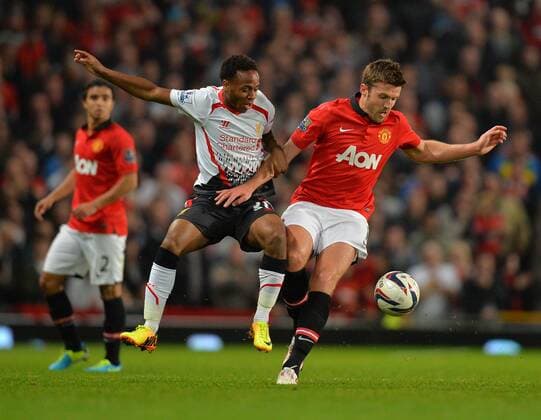 Raheem Sterling of Liverpool tussles with Michael Carrick of Manchester United - Capital One Cup - Third Round - Manchester United, ManU - FC Liverpool. Old Trafford Stadium - Manchester - 25 09 13 - PicturexSimon BellisxSportimage EDITORIAL USE ONLY. No use with unauthorised audio, video, data, fixture lists, club league logos or live services. Online in-match use limited to 120 images, no video emulation. No use in betting, games or single club league player publications.