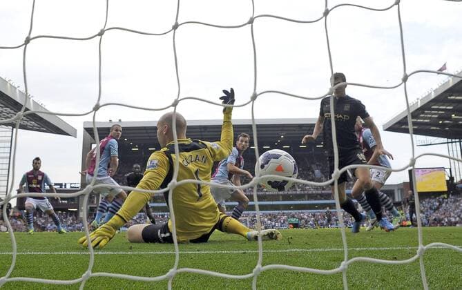 Yaya Toure of Manchester City sees his deflected shot go past Aston Villa goalkeeper Brad Guzan for City s first goal - Football - Barclays Premier League - Aston Villa vs Manchester City - Villa Park Birmingham - Season 2013-2014 - September 28th 2013 - Photograph Malcolm Couzens Sportimage EDITORIAL USE ONLY. No use with unauthorised audio, video, data, fixture lists, club league logos or live services. Online in-match use limited to 120 images, no video emulation. No use in betting, games or single club league player publications.