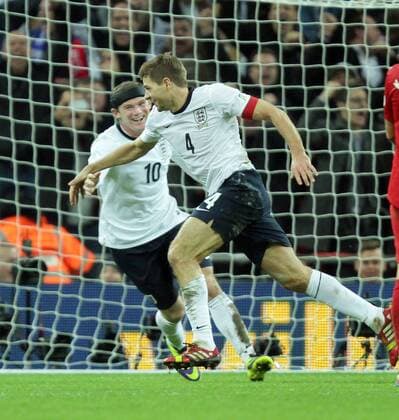 England v Poland - World Cup Qualifier . . Wembley, London, UK . . 15.10.2013 Wayne Rooney (E) runs to congratulates Steven Gerrard (E) after Gerrard scored the second England goal.