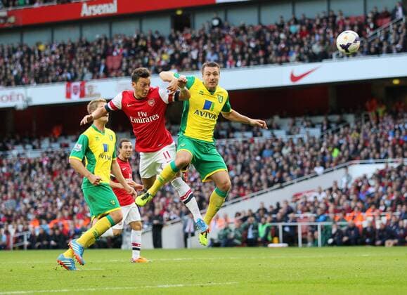 Arsenal s Mesut Ozil scoring his sides second goal Arsenal FC London v Norwich City - Barclays Premier League - Emirates Stadium - London - England -19 10 2013 - EDITORIAL USE ONLY. No use with unauthorised audio, video, data, fixture lists, club league logos or live services. Online in-match use limited to 120 images, no video emulation. No use in betting, games or single club league player publications.