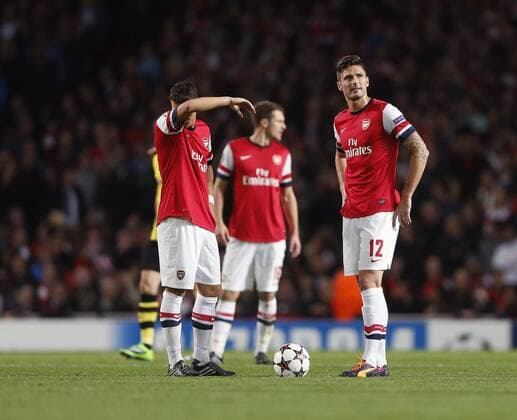 Arsenal s Mesut Ozil and Olivier Giroud look on dejected after going 1-0 down Arsenal v Dortmund - UEFA Champions League - the Emirates - London - England -22 10 2013 - Pic David Klein Sportimage EDITORIAL USE ONLY. No use with unauthorised audio, video, data, fixture lists, club league logos or live services. Online in-match use limited to 120 images, no video emulation. No use in betting, games or single club league player publications.