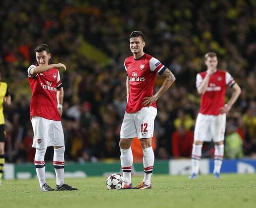 Arsenal s Mesut Ozil and Olivier Giroud look on dejected after going 2-1 down Arsenal v Dortmund - UEFA Champions League - the Emirates - London - England -22 10 2013 - Pic David Klein Sportimage EDITORIAL USE ONLY. No use with unauthorised audio, video, data, fixture lists, club league logos or live services. Online in-match use limited to 120 images, no video emulation. No use in betting, games or single club league player publications.