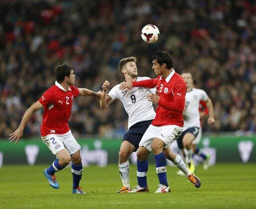 England s Adam Lallana tussles with Chile s Eugenio Mena and Marcos Gonzalez - England v Chile - International Friendly - Wembley Stadium - London - England -15 11 2013 - Pic David Klein Sportimage EDITORIAL USE ONLY. No use with unauthorised audio, video, data, fixture lists, club league logos or live services. Online in-match use limited to 120 images, no video emulation. No use in betting, games or single club league player publications.