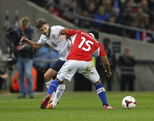 England s Adam lallana tussles with Chile s Jean Beausejour - England v Chile - International Friendly - Wembley Stadium - London - England -15 11 2013 - Pic David Klein Sportimage EDITORIAL USE ONLY. No use with unauthorised audio, video, data, fixture lists, club league logos or live services. Online in-match use limited to 120 images, no video emulation. No use in betting, games or single club league player publications.