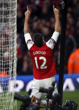 Olivier Giroud of Arsenal celebrates scoring his first goal during the Barclays Premier League match between Arsenal and Southampton at Emirates Stadium in London, Britain on Nov. 23, 2013. Arsenal won 2-0. (Xinhua Wang Lili) FOR EDITORIAL USE ONLY. NOT FOR SALE FOR MARKETING OR ADVERTISING CAMPAIGNS. NO USE WITH UNAUTHORIZED AUDIO, VIDEO, DATA, FIXTURE LISTS, CLUB LEAGUE LOGOS OR LIVE SERVICES. ONLINE IN-MATCH USE LIMITED TO 45 IMAGES, NO VIDEO EMULATION. NO USE IN BETTING, GAMES OR SINGLE CLUB LEAGUE PLAYER PUBLICATIONS. (SP)BRITAIN-LONDON-SOCCER-PREMIER LEAGUE-ARSENAL VS SOUTHAMPTON