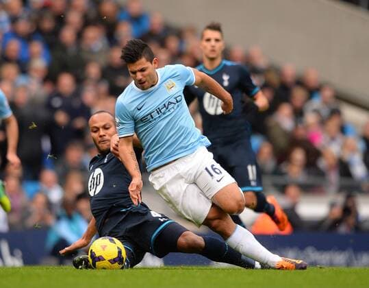 Younes Kaboul of Tottenham challenges Sergio Kun Aguero of Manchester City - Barclays Premier League - Manchester City vs Tottenham Hotspur - Etihad Stadium - Manchester - England - 24th November 2013 - EDITORIAL USE ONLY. No use with unauthorised audio, video, data, fixture lists, club league logos or live services. Online in-match use limited to 120 images, no video emulation. No use in betting, games or single club league player publications.