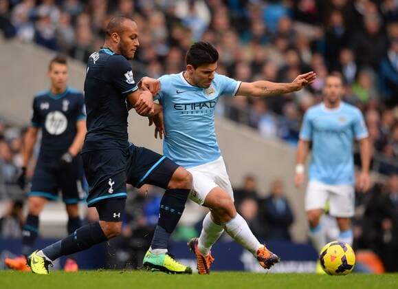 Younes Kaboul of Tottenham challenges Sergio Kun Aguero of Manchester City - Barclays Premier League - Manchester City vs Tottenham Hotspur - Etihad Stadium - Manchester - England - 24th November 2013 - EDITORIAL USE ONLY. No use with unauthorised audio, video, data, fixture lists, club league logos or live services. Online in-match use limited to 120 images, no video emulation. No use in betting, games or single club league player publications.