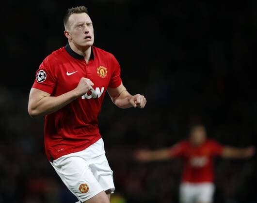 Phil Jones of Manchester United celebrates scoring during the UEFA Champions League Group A match between Manchester United and Shakhtar Donetsk at Old Trafford Stadium in Manchester, Britain on Dec. 10, 2013. Manchester United won 1-0. (Xinhua Wang Lili) (SP)BRITAIN-MANCHESTER-SOCCER-UEFA CHAMPIONS LEAGUE-GROUP A-MAN UTD VS DONETSK