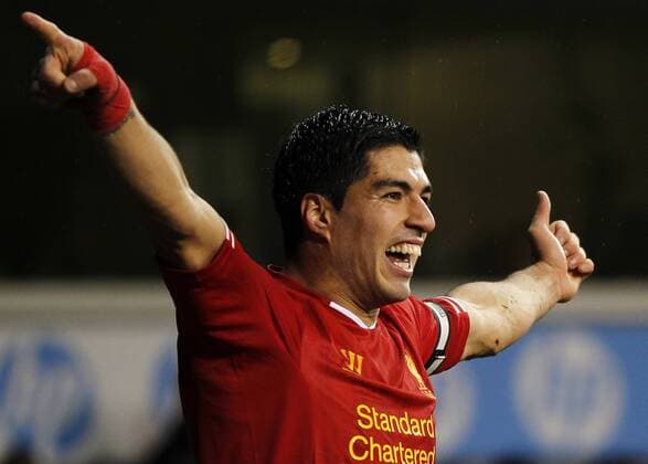 Luis Suarez of Liverpool celebrates scoring their fourth goal during the Barclays Premier League match between Tottenham Hotspur and Liverpool at White Hart Lane in London, Britain on Dec. 15, 2013. Liverpool won 5-0. (Xinhua Wang Lili) FOR EDITORIAL USE ONLY. NOT FOR SALE FOR MARKETING OR ADVERTISING CAMPAIGNS. NO USE WITH UNAUTHORIZED AUDIO, VIDEO, DATA, FIXTURE LISTS, CLUB LEAGUE LOGOS OR LIVE SERVICES. ONLINE IN-MATCH USE LIMITED TO 45 IMAGES, NO VIDEO EMULATION. NO USE IN BETTING, GAMES OR SINGLE CLUB LEAGUE PLAYER PUBLICATIONS. (SP)BRITAIN-LONDON-SOCCER-PREMIER LEAGUE-TOTTENHAM HOTSPUR VS LIVERPOOL