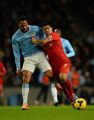 Joleen Lescott of Manchester City tussles with Luis Suarez of Liverpool - Barclays Premier League - Manchester City vs Liverpool - Etihad Stadium - Manchester - England - 26th December 2013 - Picture Simon Bellis Sportimage EDITORIAL USE ONLY. No use with unauthorised audio, video, data, fixture lists, club league logos or live services. Online in-match use limited to 120 images, no video emulation. No use in betting, games or single club league player publications.