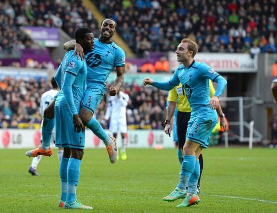 Emmanuel Adebayor of Tottenham celebrates the third goal with Danny Rose and Christian Eriksen of Tottenham - Barclays Premier League - Swansea City vs Tottenham Hotspur - Liberty Stadium - Swansea - Wales - 19th January 2014 - EDITORIAL USE ONLY. No use with unauthorised audio, video, data, fixture lists, club league logos or live services. Online in-match use limited to 120 images, no video emulation. No use in betting, games or single club league player publications.