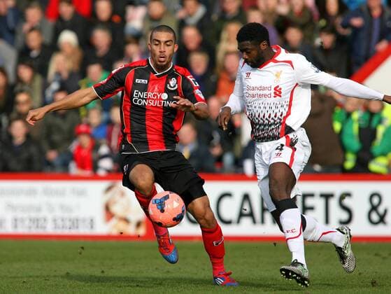 Football - 2013 2014 FA Cup - Fourth Round: AFC Bournemouth vs. Liverpool FC Kolo Toure of Liverpool and Bournemouth s Lewis Grabban tussle for a lose ball at Dean Court The Goldsands Stadium Colorsport ShaunxBoggust