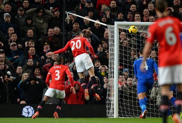 Robin van Persie of Manchester United heads the first goal - Barclays Premier League - Manchester United (ManU) vs Cardiff City - Old Trafford Stadium - Manchester - England - 28th January 2014 - EDITORIAL USE ONLY. No use with unauthorised audio, video, data, fixture lists, club league logos or live services. Online in-match use limited to 120 images, no video emulation. No use in betting, games or single club league player publications.