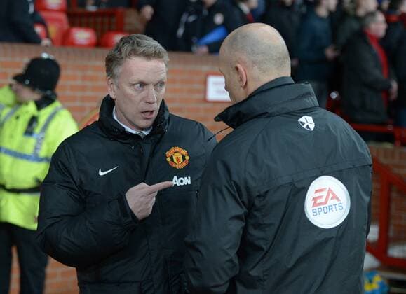 David Moyes manager of Manchester United talks to fourth official Howard Webb - Barclays Premier League - Manchester United (ManU) vs Cardiff City - Old Trafford Stadium - Manchester - England - 28th January 2014 - EDITORIAL USE ONLY. No use with unauthorised audio, video, data, fixture lists, club league logos or live services. Online in-match use limited to 120 images, no video emulation. No use in betting, games or single club league player publications.