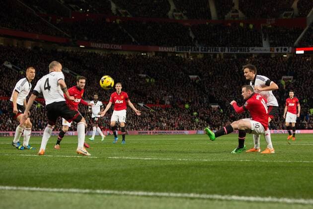 Wayne Rooney of Manchester United strikes at goal - Manchester United vs. Fulham - Barclays Premier League - Old Trafford - Manchester - 09 02 2014 Pic Philip Oldham Sportimage EDITORIAL USE ONLY. No use with unauthorised audio, video, data, fixture lists, club league logos or live services. Online in-match use limited to 120 images, no video emulation. No use in betting, games or single club league player publications.