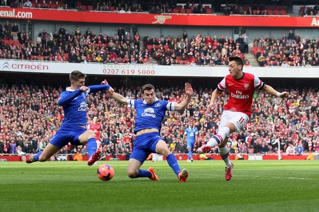 Arsenal s Mesut Ozil scoring his sides opening goal Arsenal v Everton - FA Cup Quarter Final - Emirates Stadium - London - England - 08 03 2014 - Pic David Klein Sportimage EDITORIAL USE ONLY. No use with unauthorised audio, video, data, fixture lists, club league logos or live services. Online in-match use limited to 120 images, no video emulation. No use in betting, games or single club league player publications.