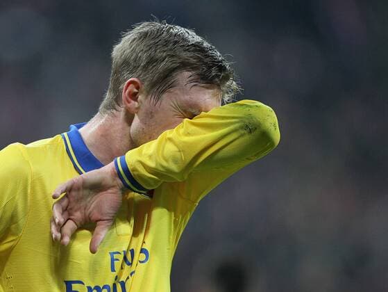 Arsenal s Per Mertesacker looks on dejected Bayern Munich v Arsenal - Champions League last 16 - Allianz Arena - Munich - Germany - 11 03 2014 - Pic DavidKlein Sportimage EDITORIAL USE ONLY. No use with unauthorised audio, video, data, fixture lists, club league logos or live services. Online in-match use limited to 120 images, no video emulation. No use in betting, games or single club league player publications.