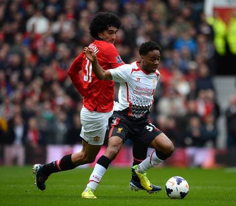 Raheem Sterling of Liverpool tussles with Mauroane Fellaini of Manchester United - Barclays Premier League - Manchester Utd vs Liverpool - Old Trafford Stadium - Manchester - England - 16th March 2014 - Pic Simon Bellis Sportimage EDITORIAL USE ONLY. No use with unauthorised audio, video, data, fixture lists, club league logos or live services. Online in-match use limited to 120 images, no video emulation. No use in betting, games or single club league player publications.