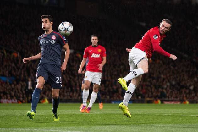 Wayne Rooney of Manchester United sends a header onto the post - UEFA Champions League Round of 16 - Manchester United vs. Olympiacos - Old Trafford - Manchester - England - 19th March 2014 - Picture Philip Oldham Sportimage EDITORIAL USE ONLY. No use with unauthorised audio, video, data, fixture lists, club league logos or live services. Online in-match use limited to 120 images, no video emulation. No use in betting, games or single club league player publications.