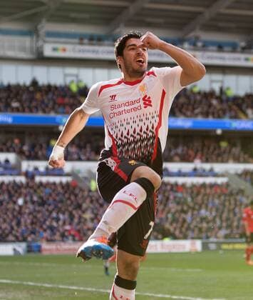 Luis Suarez of Liverpool celebrates scoring his sides fourth goal - Barclays Premier League - Cardiff City vs. FC Liverpool - Cardiff City Stadium - Cardiff - Wales - 22nd March 2014 - EDITORIAL USE ONLY. No use with unauthorised audio, video, data, fixture lists, club league logos or live services. Online in-match use limited to 120 images, no video emulation. No use in betting, games or single club league player publications.