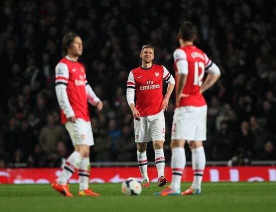 Arsenal s Per Mertesacker looks on dejected after going 1-0 down Arsenal vs Swansea City - Premier League - Emirates Stadium- London - England - 25 03 2014 - Pic David Klein Sportimage EDITORIAL USE ONLY. No use with unauthorised audio, video, data, fixture lists, club league logos or live services. Online in-match use limited to 120 images, no video emulation. No use in betting, games or single club league player publications.