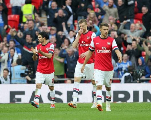 Arsenal s Per Mertesacker looks on dejected after conceding a penalty Wigan Athletic vs Arsenal- FA Cup Semi Final, Wembley Stadium - London - England - 12 04 2014 - Pic David Klein Sportimage EDITORIAL USE ONLY. No use with unauthorised audio, video, data, fixture lists, club league logos or live services. Online in-match use limited to 120 images, no video emulation. No use in betting, games or single club league player publications.