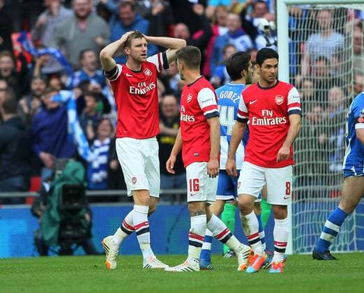 Arsenal s Per Mertesacker looks on dejected after conceding a penalty Wigan Athletic vs Arsenal- FA Cup Semi Final, Wembley Stadium - London - England - 12 04 2014 - Pic David Klein Sportimage EDITORIAL USE ONLY. No use with unauthorised audio, video, data, fixture lists, club league logos or live services. Online in-match use limited to 120 images, no video emulation. No use in betting, games or single club league player publications.