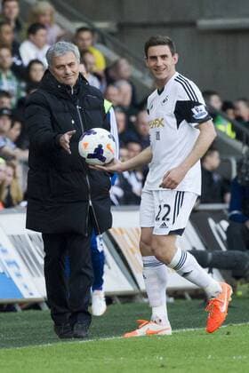 Football - 2013 2014 Premier League - Swansea City vs. Chelsea Chelsea manager José Mourinho hands the ball to Angel Rangel of Swansea on the touchline at the the Liberty Stadium. COLORSPORT WINSTON BYNORTH