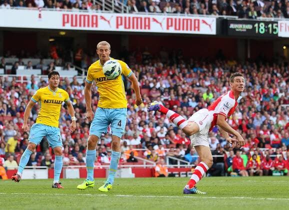 Arsenal s Laurent Koscielny scoring his sides opening goal - Barclays Premier League - Arsenal vs Crystal Palace - Emirates Stadium - London - England - 16th August 2014 - Picture David Klein Sportimage EDITORIAL USE ONLY. No use with unauthorised audio, video, data, fixture lists, club league logos or live services. Online in-match use limited to 120 images, no video emulation. No use in betting, games or single club league player publications.