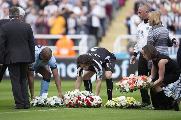 Vincent Kompany of Manchester City and Fabricio Coloccini of Newcastle United lay wreaths in memory of the two Newcastle fans who died onboard MH17 - Newcastle United vs. Manchester City - Barclays Premier League - St James Park - Newcastle - 17 08 2014 Pic Philip Oldham Sportimage EDITORIAL USE ONLY. No use with unauthorised audio, video, data, fixture lists, club league logos or live services. Online in-match use limited to 120 images, no video emulation. No use in betting, games or single club league player publications.