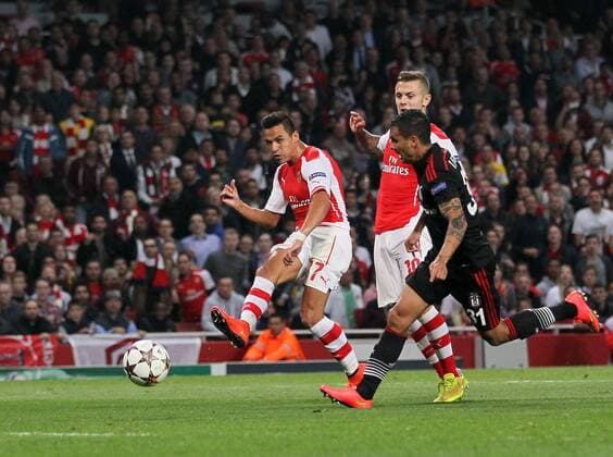 Arsenal s Alexis Sanchez scoring his sides opening goal - UEFA Champions League, Play-off Second Leg - Emirates Stadium - England - 27th August 2014 - Picture David Klein Sportimage EDITORIAL USE ONLY. No use with unauthorised audio, video, data, fixture lists, club league logos or live services. Online in-match use limited to 120 images, no video emulation. No use in betting, games or single club league player publications.