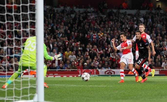 Arsenal s Alexis Sanchez scoring his sides opening goal - UEFA Champions League, Play-off Second Leg - Emirates Stadium - England - 27th August 2014 - Picture David Klein Sportimage EDITORIAL USE ONLY. No use with unauthorised audio, video, data, fixture lists, club league logos or live services. Online in-match use limited to 120 images, no video emulation. No use in betting, games or single club league player publications.