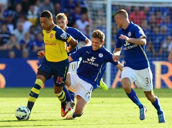 Alex Oxlade-Chamberlain of Arsenal tackled by Dean Hammond of Leicester City - Barclays Premier League - Leicester City vs Arsenal FC London - England - 30th August 2014 - EDITORIAL USE ONLY. No use with unauthorised audio, video, data, fixture lists, club league logos or live services. Online in-match use limited to 120 images, no video emulation. No use in betting, games or single club league player publications.