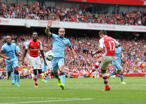 Arsenal s Alexis Sanchez scoring his sides second goal - Barclays Premier League - FC Arsenal London v Manchester City - Emirates Stadium - England - 13th September 2014 -EDITORIAL USE ONLY. No use with unauthorised audio, video, data, fixture lists, club league logos or live services. Online in-match use limited to 120 images, no video emulation. No use in betting, games or single club league player publications.