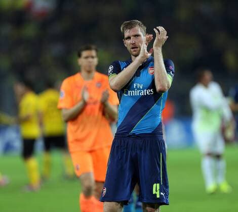 Arsenal s Per Mertesacker looks on dejected at the final whistle - Champions League Group D - Borussia Dortmund vs Arsenal London - Signal Iduna Park - Germany - 16th September 2014 - EDITORIAL USE ONLY. No use with unauthorised audio, video, data, fixture lists, club league logos or live services. Online in-match use limited to 120 images, no video emulation. No use in betting, games or single club league player publications.