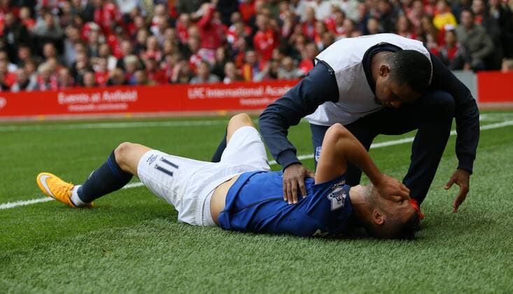 Kevin Mirallas of Everton pulls up with a hamstring problem and is comforted by Samuel Eto - Barclays Premier League - Liverpool vs Everton - Anfield Stadium - Liverpool - England - 27th September 2014 - Picture Simon Bellis Sportimage EDITORIAL USE ONLY. No use with unauthorised audio, video, data, fixture lists, club league logos or live services. Online in-match use limited to 120 images, no video emulation. No use in betting, games or single club league player publications.