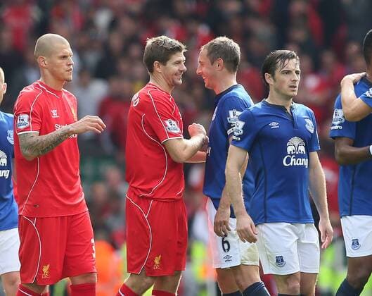 The two goalscorers Steven Gerrard of Liverpool and Phil Jagielka of Everton smile at the end of the match - Barclays Premier League - Liverpool vs Everton - Anfield Stadium - Liverpool - England - 27th September 2014 - EDITORIAL USE ONLY. No use with unauthorised audio, video, data, fixture lists, club league logos or live services. Online in-match use limited to 120 images, no video emulation. No use in betting, games or single club league player publications.
