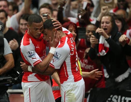 Arsenal s Alex Oxlade-Chamberlain celebrates scoring his sides opening goal - Barclays Premier League - Arsenal vs Tottenham Hotspur - Emirates Stadium - England - 27th September 2014 - EDITORIAL USE ONLY. No use with unauthorised audio, video, data, fixture lists, club league logos or live services. Online in-match use limited to 120 images, no video emulation. No use in betting, games or single club league player publications.